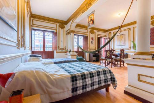 a bedroom with a bed in a room at Casa del Sol in Bogotá