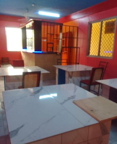 a room with tables and chairs in a room at Mtomo vision in Mtwapa