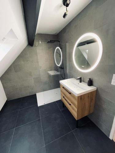 a bathroom with a sink and a mirror at La Guignicourtoise in Guignicourt
