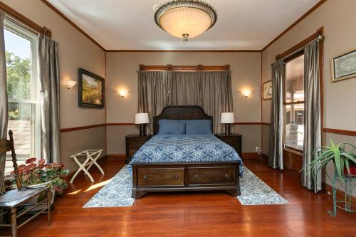 a bedroom with a bed and a large window at 1895 Victorian Home on Historic Walnut Street in Springfield