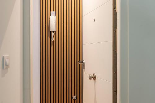 a bathroom stall with a door with a candle on it at Casa Naranjo - Plaza Mayor Almagro in Almagro