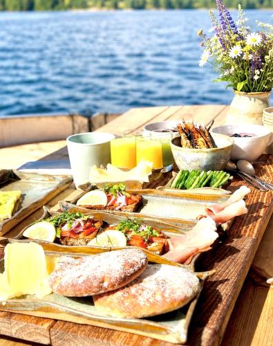 a tray of food on a table next to the water at Saimaa Experience in Savonlinna
