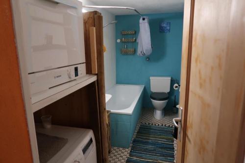 a small bathroom with a toilet and a sink at Lakeview Chalet 1 , Drligen in Därligen