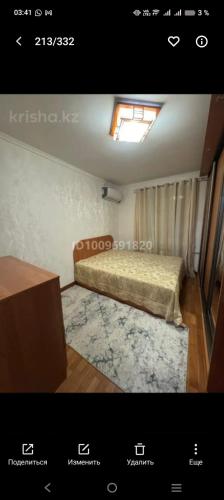 a small room with a bed and a window at Уютный уголок in Aktobe