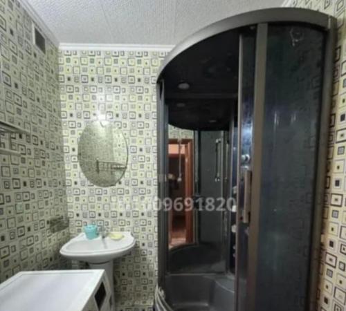 a bathroom with a shower and a sink at Уютный уголок in Aktobe