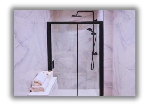 a bathroom with a shower and a roll of toilet paper at The Red Lounge Rooms in Liverpool