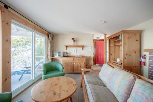 a living room with a couch and a table at 136 Birdie Simcoe Cottage private Beach, Kayak in Georgina