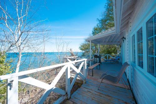 a porch of a house with a view of the ocean at 136 Birdie Simcoe Cottage private Beach, Kayak in Georgina