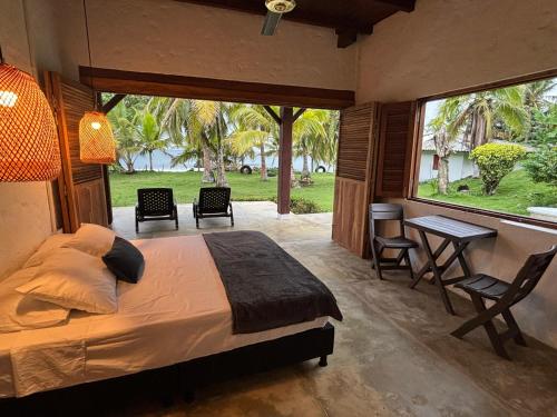 a bedroom with a bed and a table and chairs at Mareselva Lodge in Acanti