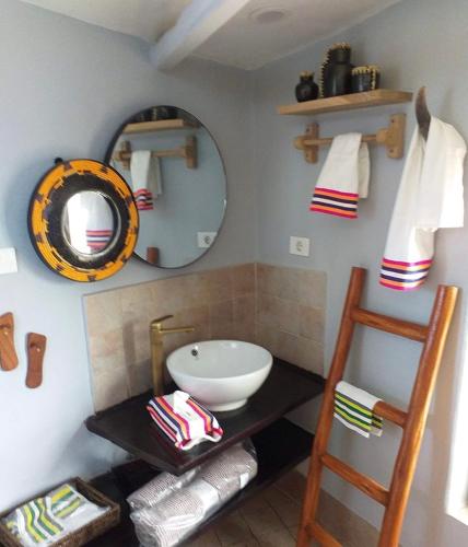 a bathroom with a sink and a mirror at Rimbud guest house in Hārer