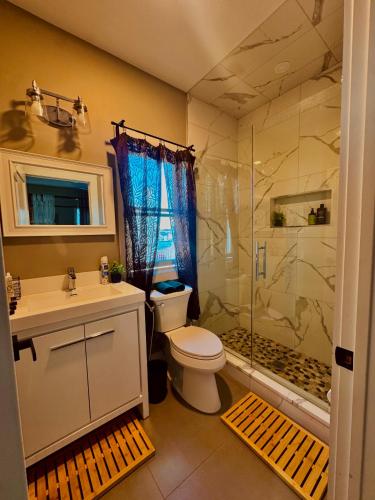 a bathroom with a toilet and a shower and a sink at Master Suite De Carlo Shared Property PRIVATE stay NYC 18mins in North Bergen