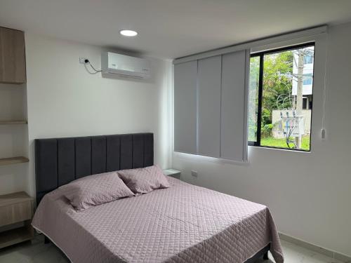 a bedroom with a bed and a window at Hermosos Apartaestudios! in Florencia