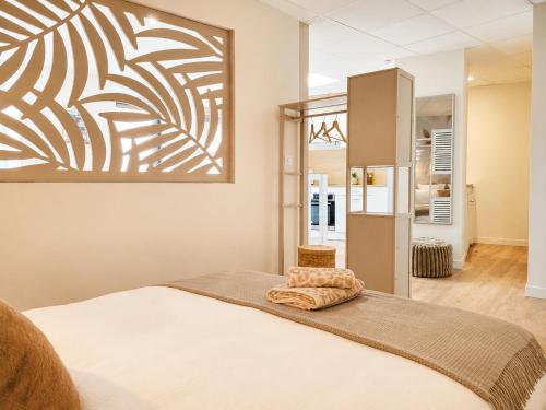 a bedroom with a bed and a mirror at La Maison De Colette in Lezoux