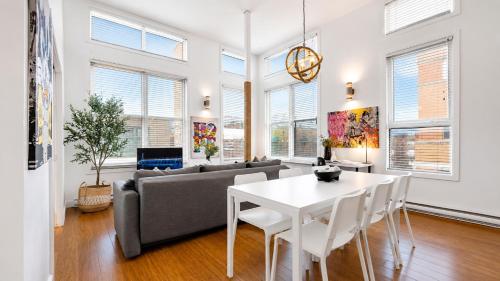 a living room with a couch and a table at LiV MTL Main Plateau Suites Near Downtown Montreal in Montreal