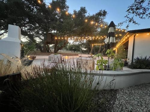 a garden at night with lights and an umbrella at Wranglers Rest Ranch in Arroyo Grande