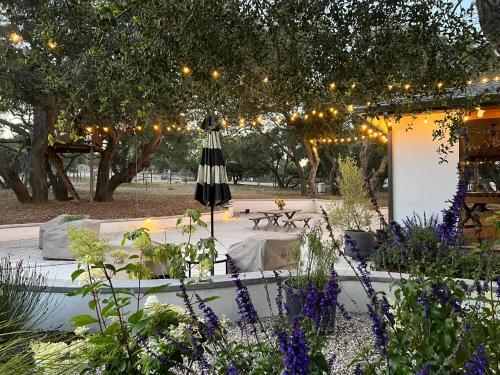 a patio with a table and an umbrella and lights at Wranglers Rest Ranch in Arroyo Grande