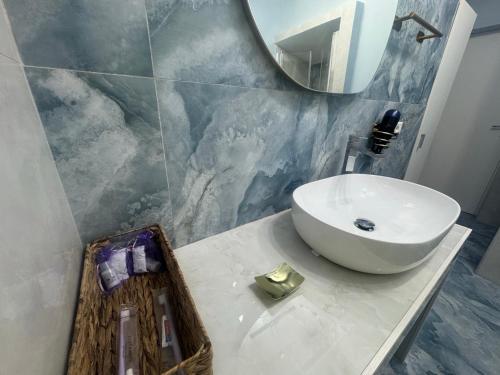 a bathroom with a sink and a mirror at Casa Vacanze Aurelia in Procida