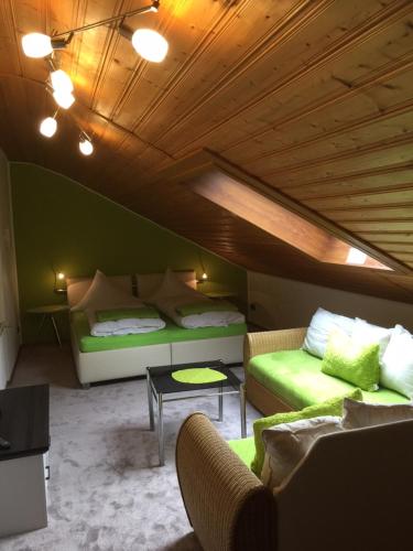 a living room with two beds and a couch at Landhaus Am Forst in Bad Alexandersbad