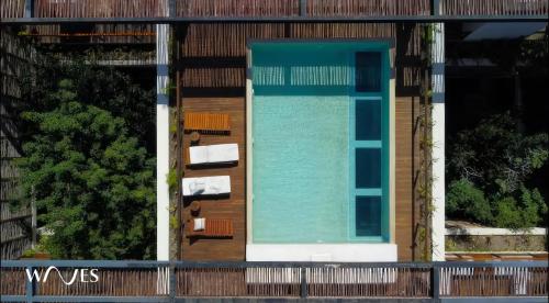 an overhead view of a swimming pool on a building at Amelia By Waves in Tulum