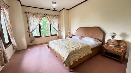 a bedroom with a bed and a large window at Villa Kay Serenity in Sampal 2