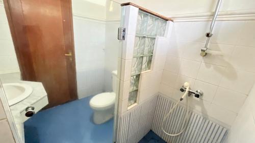 a bathroom with a toilet and a blue floor at Villa Kay Serenity in Sampal 2