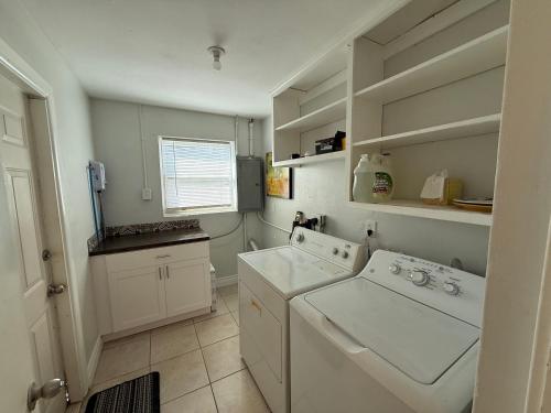 a white laundry room with a washer and dryer at Rosewood 1 in Vero Beach