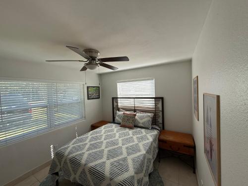 a bedroom with a bed and a ceiling fan at Rosewood 1 in Vero Beach