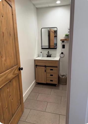 a bathroom with a sink and a mirror at Sleep at Simplicity in Massena