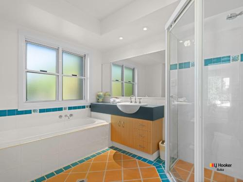 a bathroom with a tub and a sink and a shower at Riverview Apartment 1.4 in Iluka