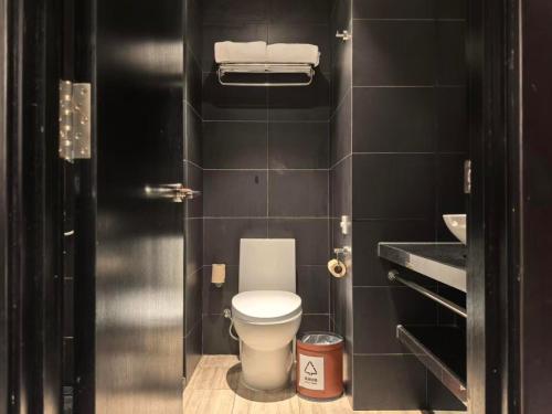 a small bathroom with a toilet in a stall at Orange Hotel Beijing Summer Palace in Beijing