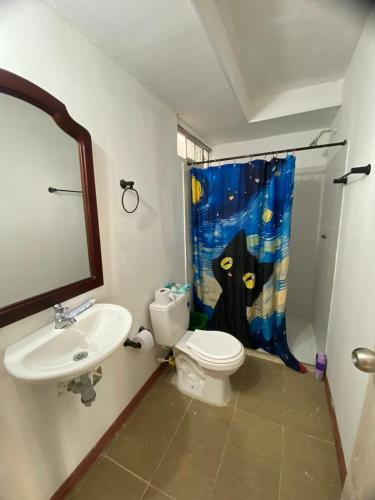 a bathroom with a sink and a toilet and a shower curtain at Apartamento en Melgar con la mejor ubicacion in Melgar