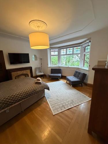 a bedroom with a bed and a living room at The Cairn in Airdrie