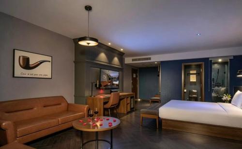 a bedroom with a bed and a living room at Orange Hotel Beijing Summer Palace in Beijing