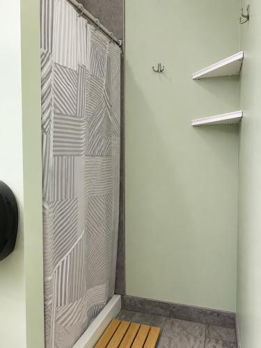 a glass shower door in a room at Hostel du Nord in Duluth