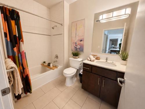 a bathroom with a sink and a toilet and a tub at Spacious, Comfortable, and Central Condo in Los Angeles