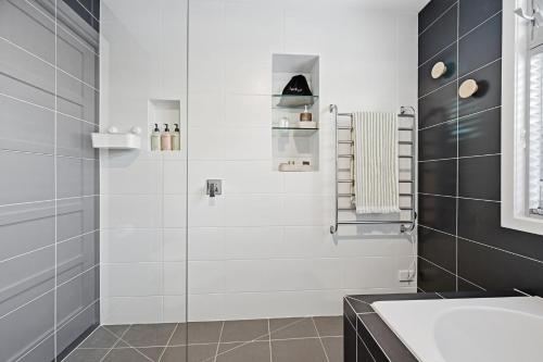 a bathroom with a shower and a sink at Tamara Coastal Retreat in Inverloch
