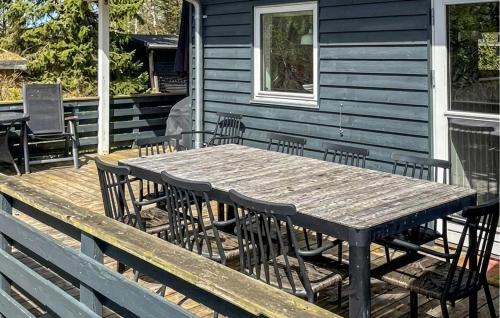 a wooden deck with a table and chairs on a house at Three-Bedroom Holiday Home In Grasted in Græsted