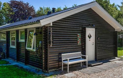 a wooden cabin with a bench in front of it at Cozy Home In Jerup With Wifi in Jerup