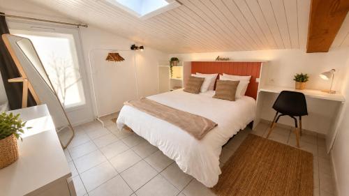 a bedroom with a large bed and a window at Gite de charme avec jaccuzzi privé in Coëx