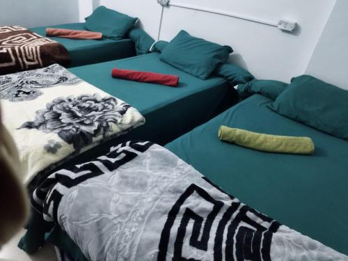 a room with two beds and a couch at Grand Backpackers Hostel Luxor in Luxor