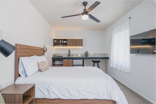 a bedroom with a bed and a small kitchen at Casa Verde in Monterrey