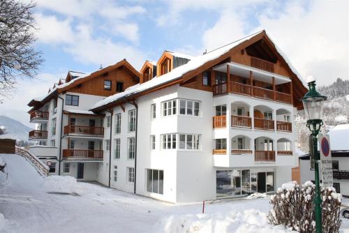 a building in the snow next to a street light at Ferienresidenz Leogangerhof in Leogang