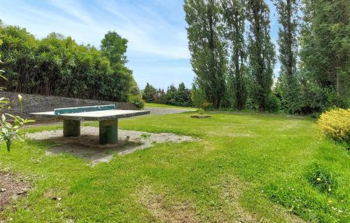 a bench in the middle of a grass field at Maison Mitoyenne Avec Spa in La Chapelle-Urée
