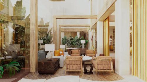 a living room with a couch and chairs at Casa de Sada Algarve Beach Resort, Curio Collection by Hilton in Armação de Pêra