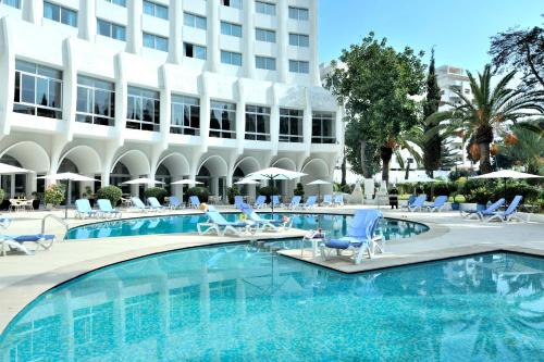 a swimming pool in front of a hotel at Kenzi Solazur in Tangier