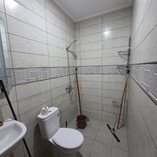 a bathroom with a toilet and a sink at Lmadghri6 in Ras El Ma