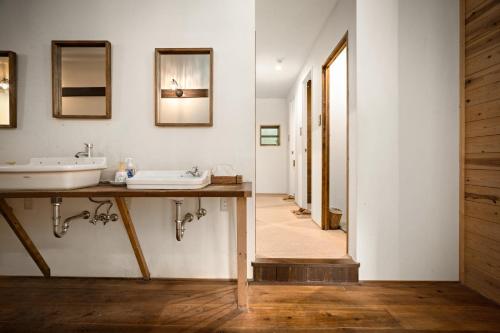 a bathroom with a sink and a mirror at The Deer Park Inn in Nara