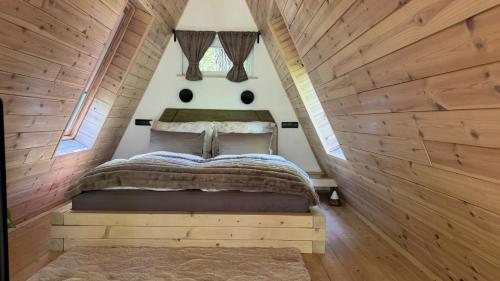 a bedroom with a bed in a small room at Fészek Lombház in Kismaros