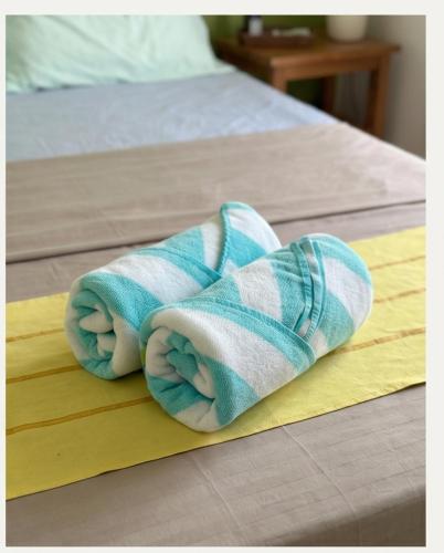 a towel sitting on top of a bed at Hooga Home in Cebu City
