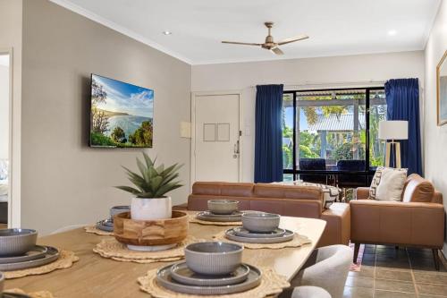 a living room with a couch and a table at Dunes Escape in Broome